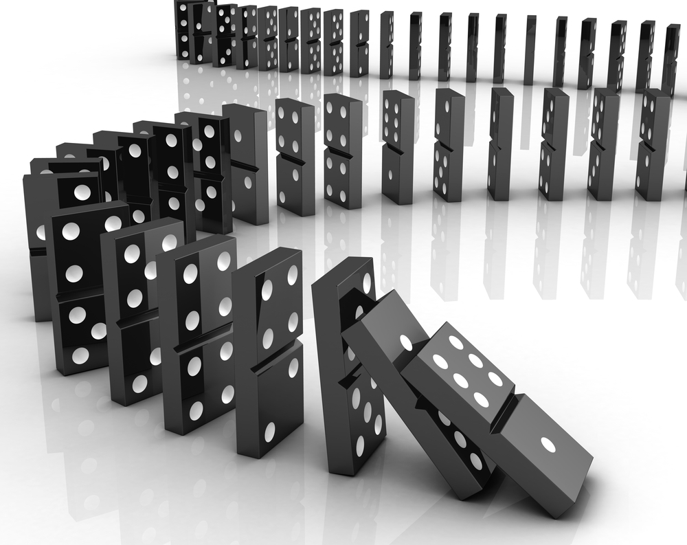 A line of falling dominoes illustrating secondary effects