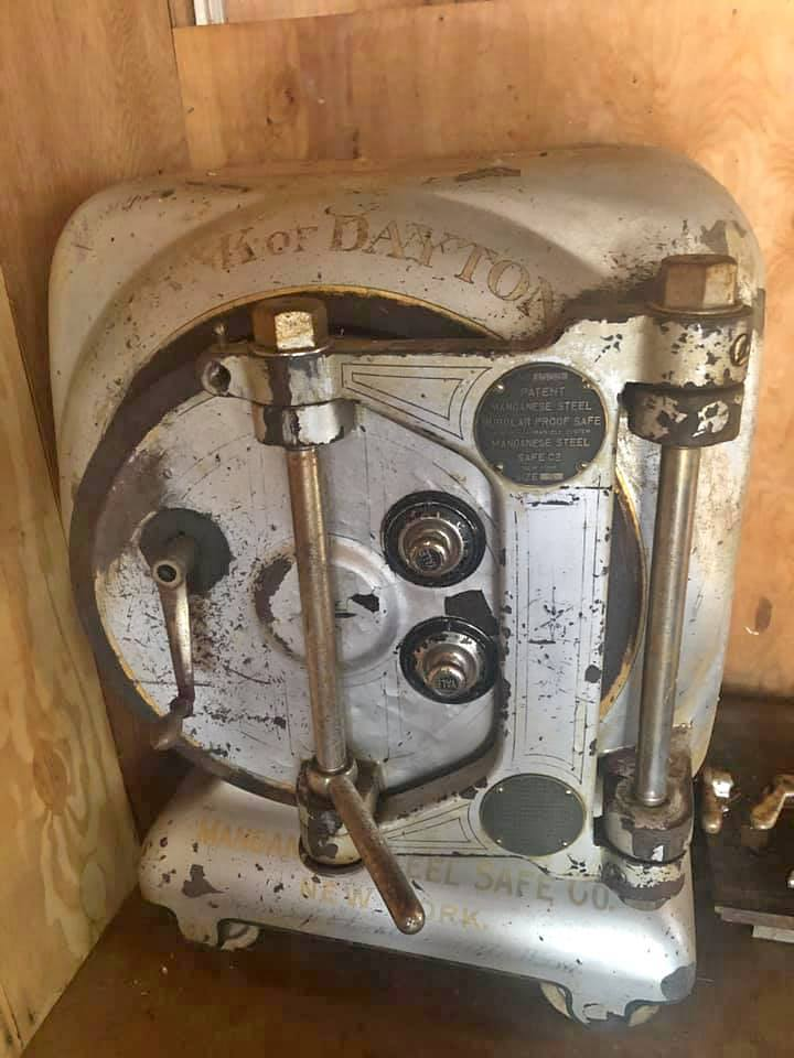 The exposed locking mechanism inside an antique safe door